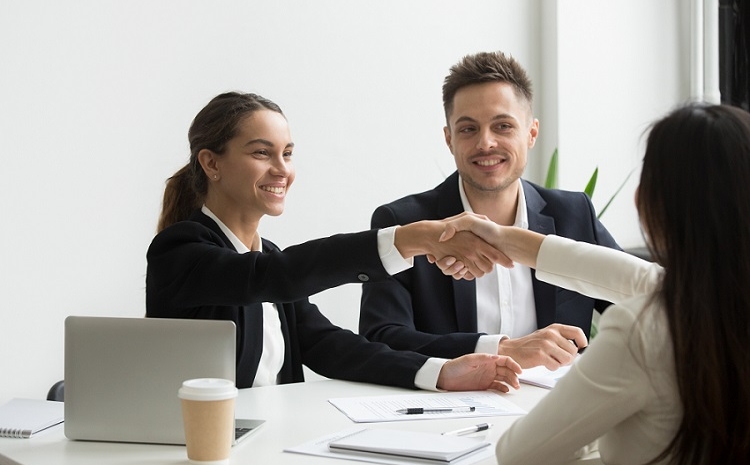 hr representatives positively greeting female job candidate
